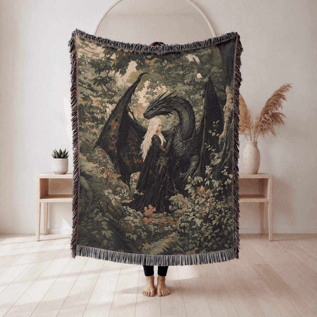 Throne of Glass-inspired blanket showing a pale-haired figure beside a dark winged creature among woodland leaves and flowers