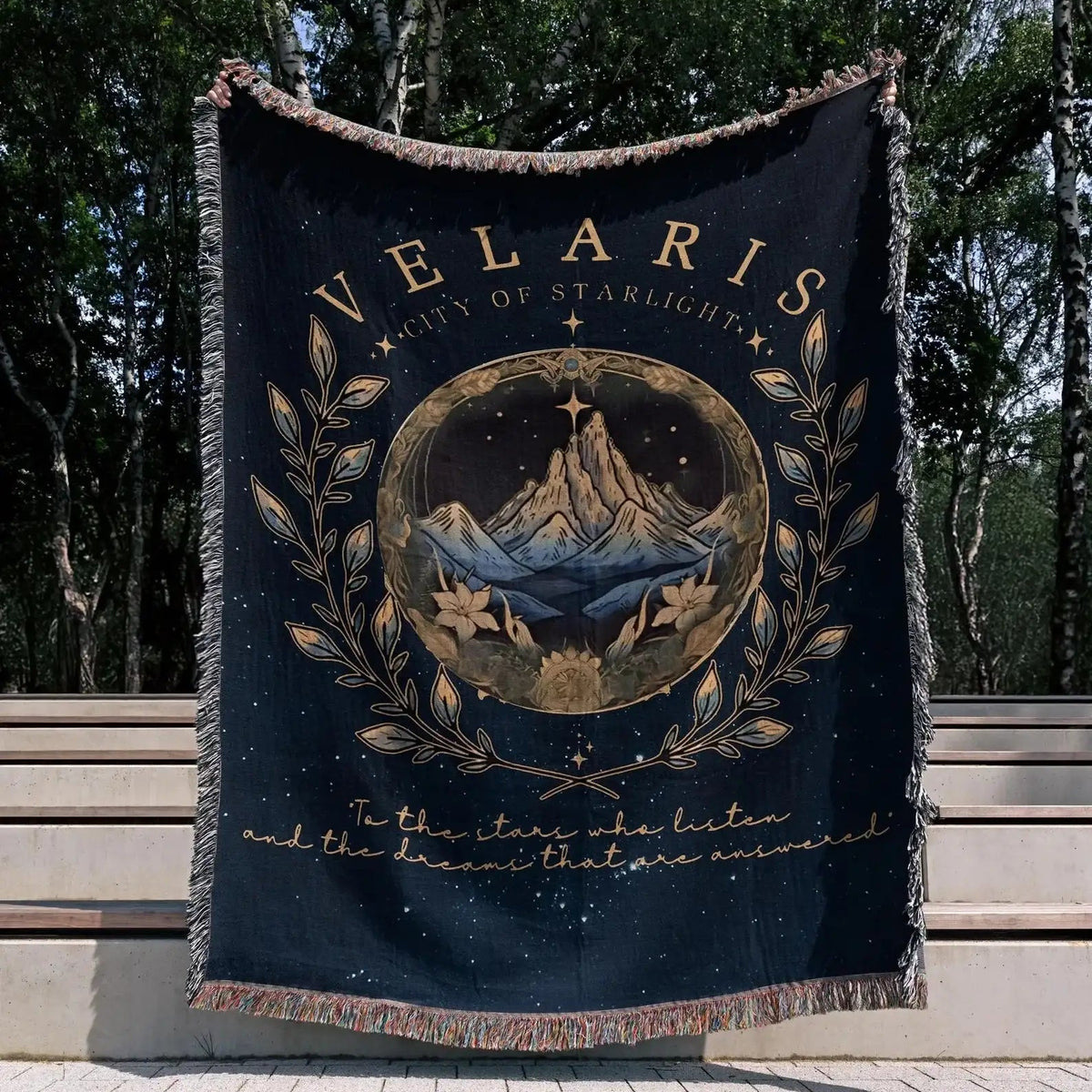 Velaris City of Starlight blanket with circular mountain artwork, stars, leafy ornament and words about listening stars and answered dreams
